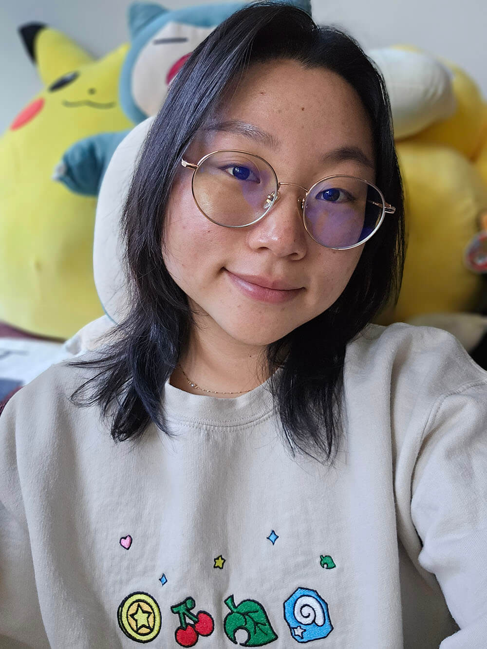 photo of Sehee Snead in front of Pokémon plushes