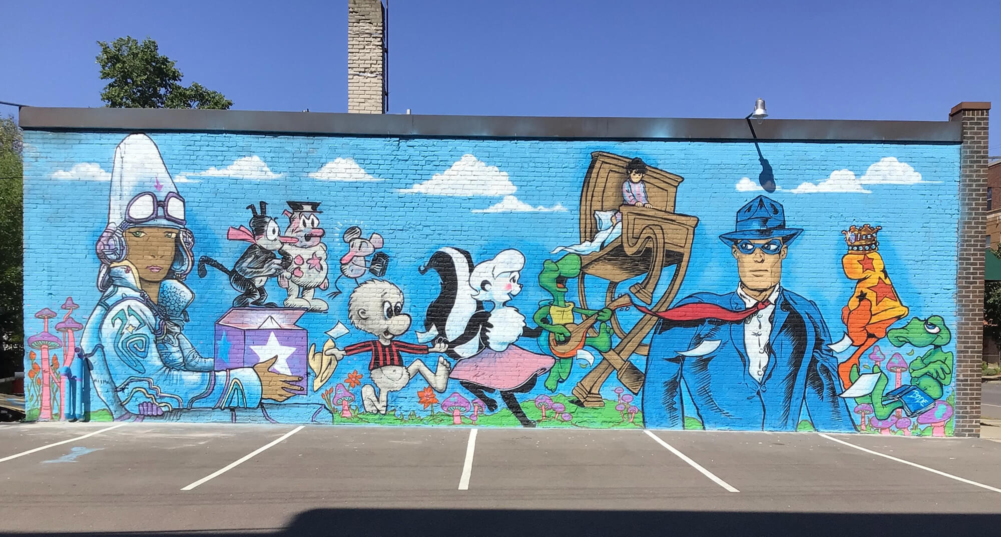 Comic Mural at DreamHaven Books & Comics in Minneapolis, MN painted mural on the side of a brick building featuring famous comic book characters in a variety of art styles